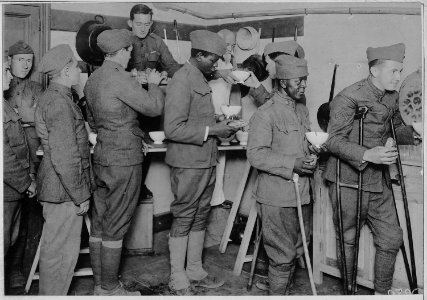 American soldiers getting their bowls of chocolate and rolls in the American Red Cross canteen at To . . . - NARA - 533533 photo