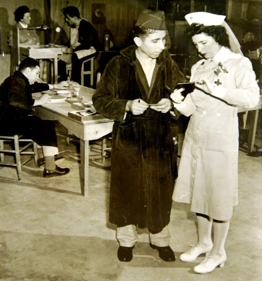 American soldier seeking assistance from volunteer teacher while making purse, WWII (34756210745)