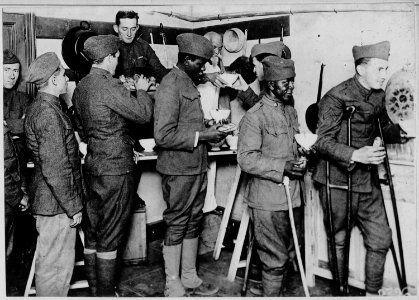 American soldiers getting their bowl of hot chocolate and rolls in the American Red Cross canteen at . . . - NARA - 533567 photo