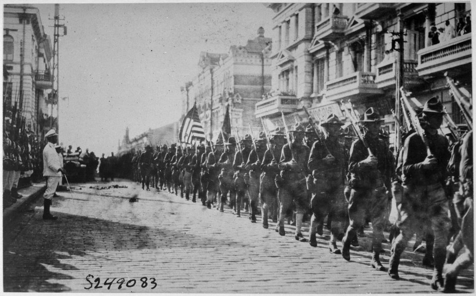 American troops in Vladivostok parading before the building occupied by the staff of the Czecho-Slovaks. Japanese marine - NARA - 533750