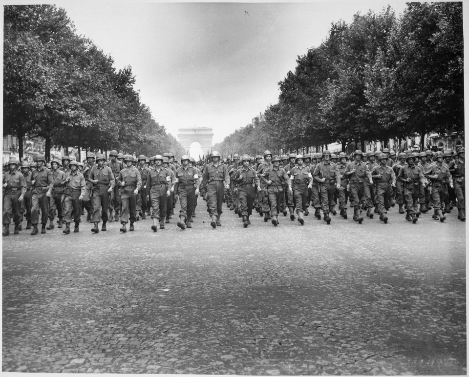American troops of the 28th Infantry Division march down the Champs Elysees, Paris, in the Victory Parade. - NARA - 531209