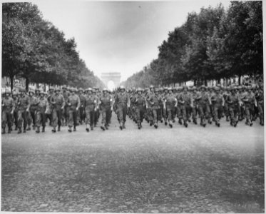 American troops of the 28th Infantry Division march down the Champs Elysees, Paris, in the Victory Parade. - NARA - 531209
