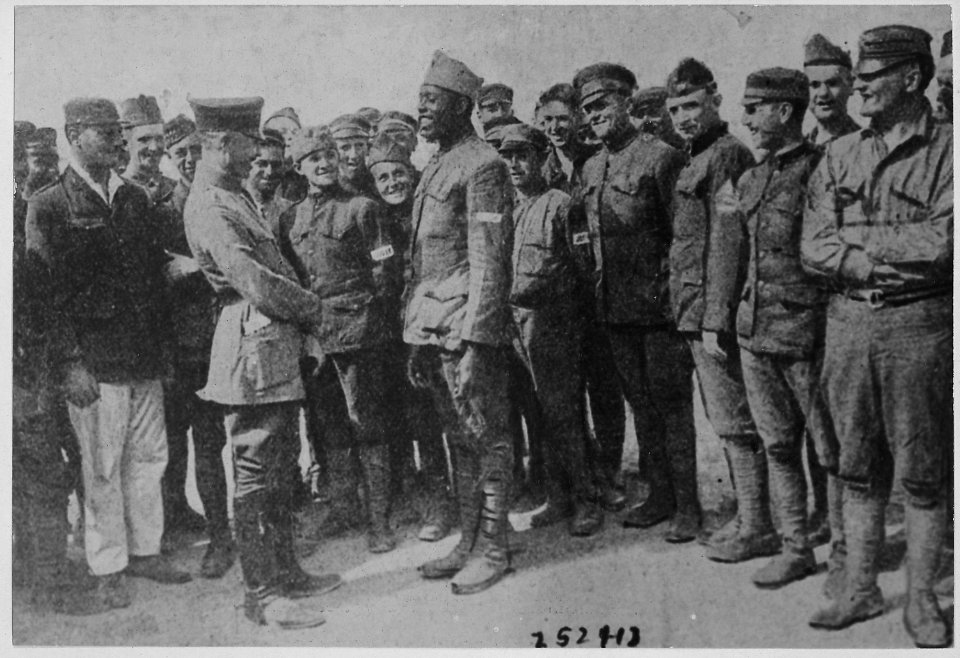 Americans in German prison camp. A group of American prisoners in a German prison camp listening at . . . - NARA - 533544