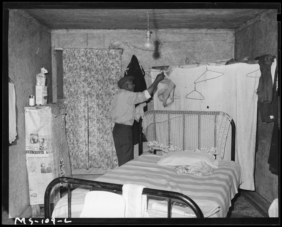 Amos Wilson, miner, in bedroom of his home in company housing project. Koppers Coal Division, Federal ^1 Mine, Grant... - NARA - 540276