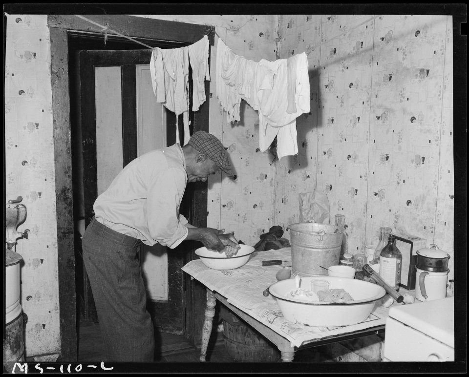 Amos Wilson, miner, washing hands in kitchen of his home. Koppers Coal Division, Federal ^1 Mine, Grant Town, Marion... - NARA - 540277
