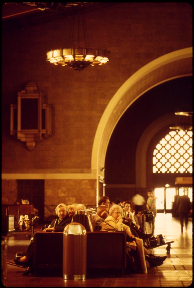 Amtrak-passengers-waiting-for-passenger-trains-in-the-interior-of-the-los-angeles-union-passenger-terminal-which-was-built-for-the-1932-summer-olympics-in-that-california-city-may-1974 7158148434 o