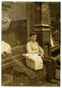An Enforced Rest. Harry Swope, aged 15, 426 Elm St., Newport, Ky., Carrying heavy bundles of paper for a News & Sta'y Co. LOC cph.3b23467