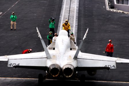 An F A-18E Super Hornet is directed onto a catapult aboard USS Ronald Reagan (5958098880)