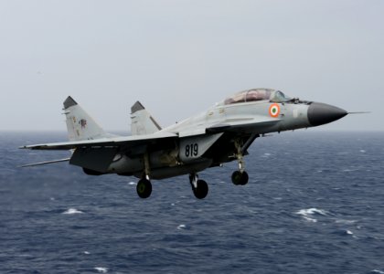 An Indian Navy MIG-29K Fulcrum flies over the aircraft carrier USS Nimitz (CVN 68) during Exercise Malabar 2017