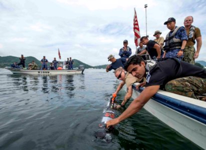 An Indian Navy Explosive Ordnance Disposal (EOD) technician and a U.S. Navy Sailor launch a MK18 Mod. One unmanned underwater vehicle during a mine countermeasures training mission near Sasebo during Exercise Malabar 2016