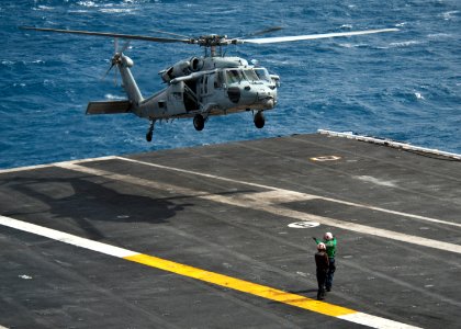 An MH-60S lands aboard USS Nimitz at sea. (8637770684)