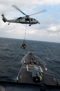An MH-60S delivers supplies to USS Mobile Bay. (8232063883)