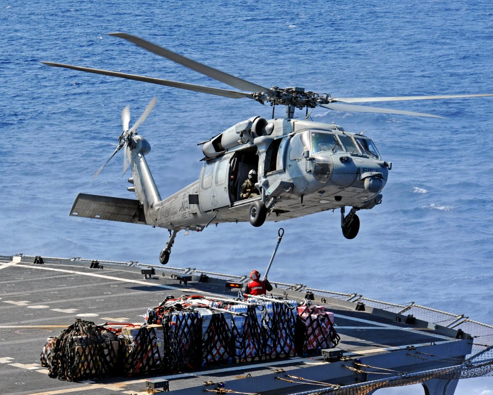 An MH-60S Sea Hawk helicopter picks up cargo from the flight deck of USNS Leroy Grumman. (29206264772)