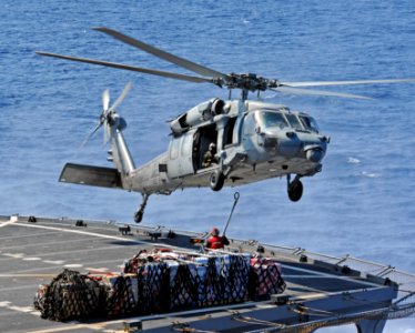An MH-60S Sea Hawk helicopter picks up cargo from the flight deck of USNS Leroy Grumman. (29206264772)