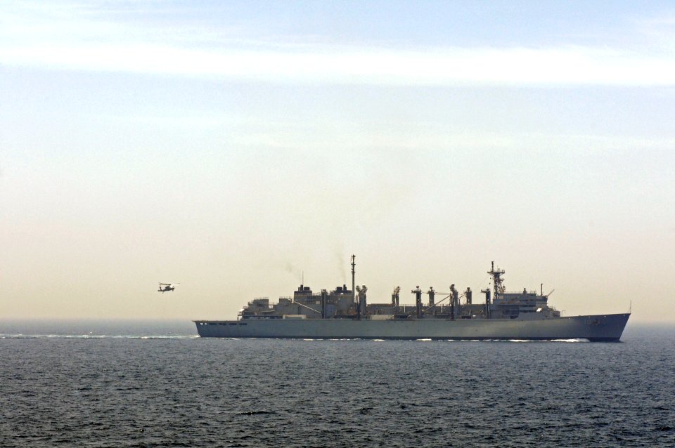 An MH-60S Seahawk helicopter assigned to Helicopter Sea Combat Squadron (HSC) 23 approaches the flight deck of the fast combat support ship USNS Bridge (T-AOE 10) after a vertical replenishment-at-sea with dock 110517-N-RC734-335