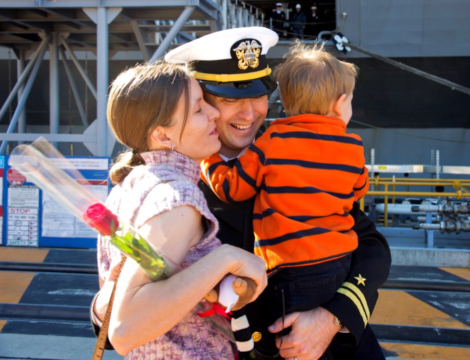 An officer hugs his children after returning home. (8205188809)