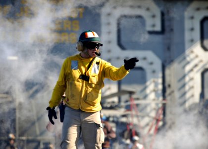 An officer prepares to launch aircraft at sea. (8185201735)