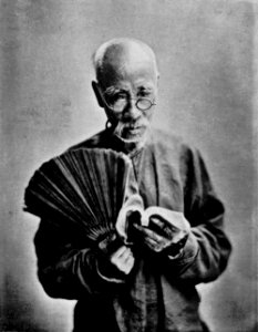 An old man with a fan