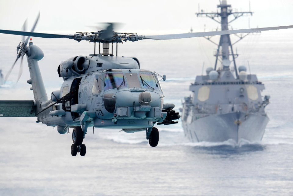 An SH-60R Sea Hawk helicopter flies ahead of USS Chung Hoon. (20532987702)