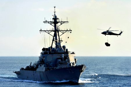 An SH-60B carries cargo to USS Decatur at sea. (8407481117)