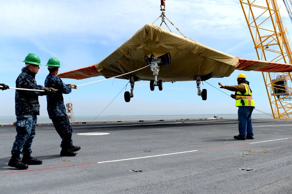 An X-47B is loaded onto flight deck aboard USS George H.W. Bush. (8721193532)