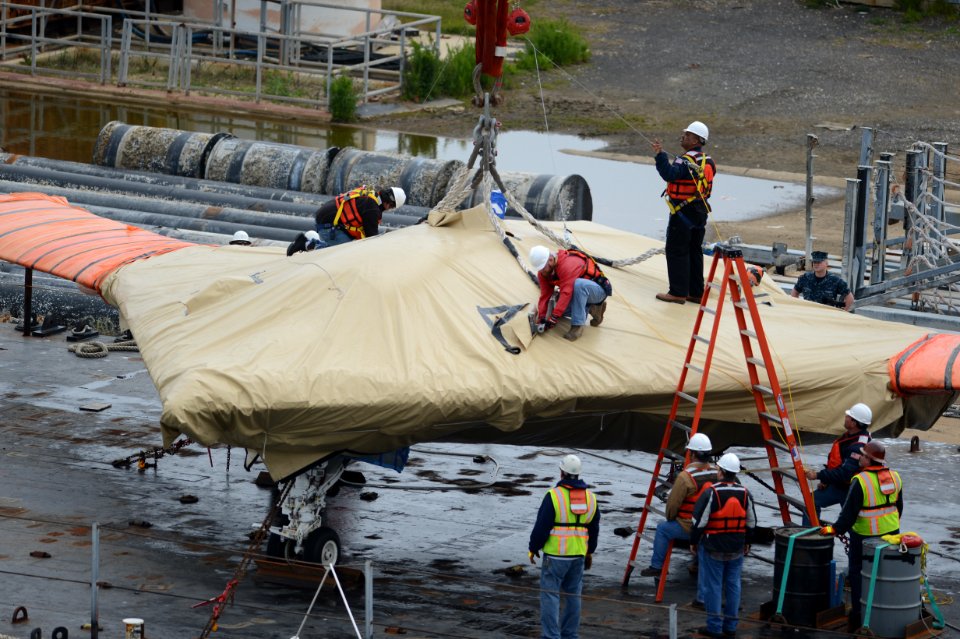 An X-47B is loaded onto flight deck of USS George H.W. Bush. (8720066959)