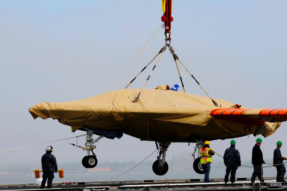 An X-47B is loaded onto flight deck of USS George H.W. Bush. (8720066597)