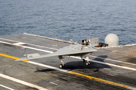 An X-47B conducts a touch and go landing. (8788886904)