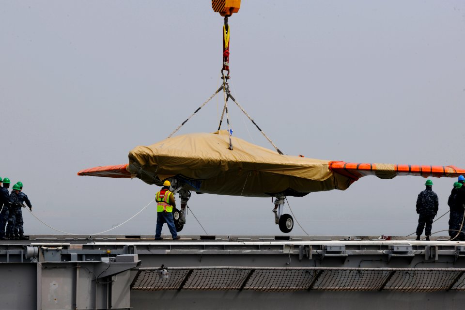 An X-47B is loaded onto flight deck of USS George H.W. Bush. (8721189800)