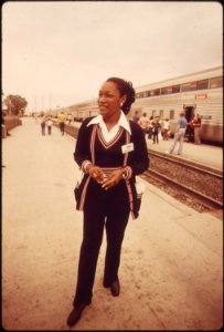 An-amtrak-passenger-service-representative-stands-ready-to-answer-questions-concerning-train-travel-june-1974 7158176848 o photo