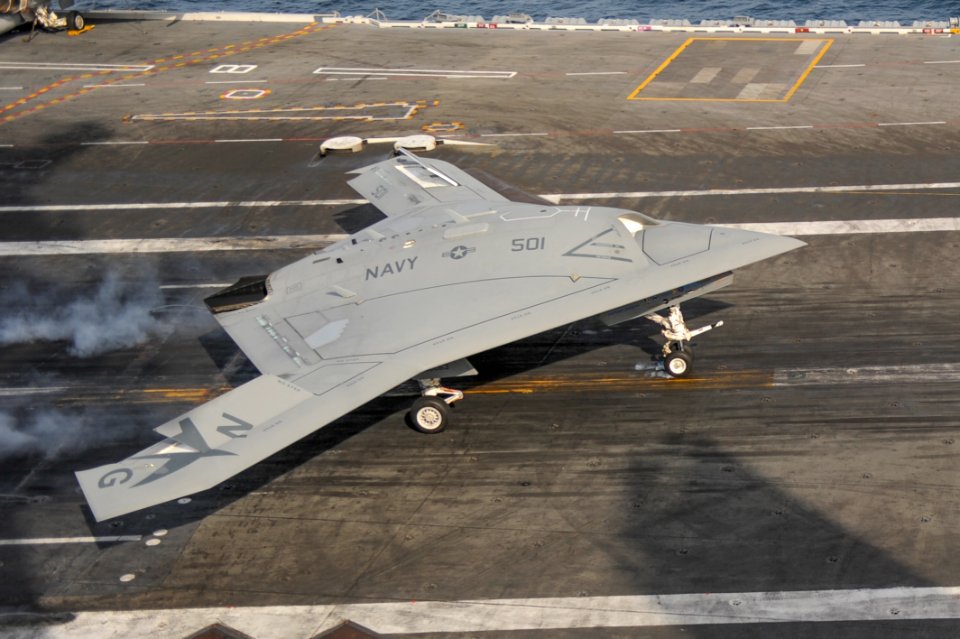 An X-47B conducts a touch and go landing. (8782295675)