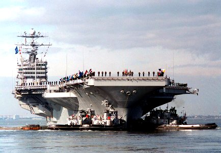 Bow view of USS George Washington (CVN-73) being assisted by tugs during departure for Operation Joint Endeavor 960126-N-6442M-002