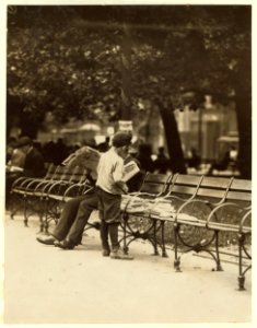 Boy collecting discarded papers in Union Square. He sells them to store-keepers. LOC nclc.03647