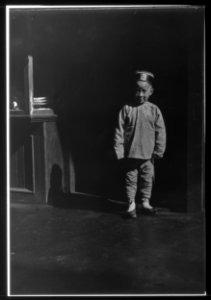 Boy in doorway of lamp store, Chinatown, San Francisco LOC agc.7a55053