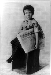 Boy posed with a copy of The Milwaukee Sentinel LCCN2003671103