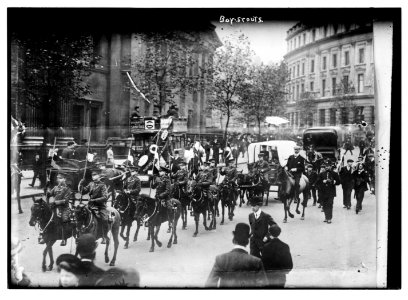 Boy Scouts. Marching on horseback down a street. LCCN2014688144