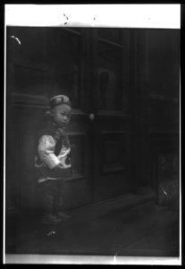 Boy standing in front of a doorway, Chinatown, San Francisco LOC agc.7a55101
