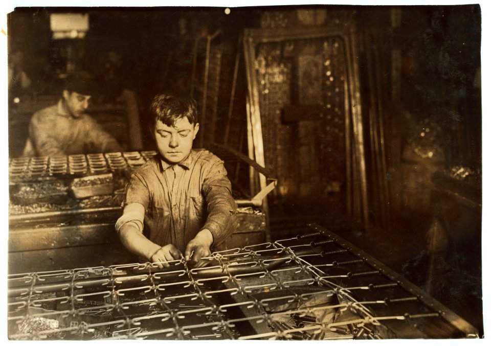Boys 'linking' bed-springs. 14 and 15 years old. LOC nclc.05607