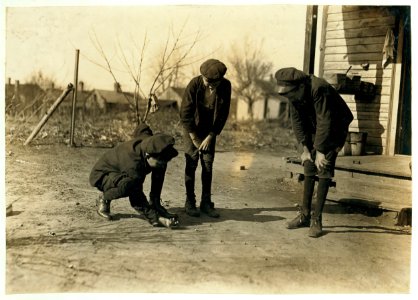 Brantley Henson (boy near porch). Been in mill 8 years. Jasper Henson, (in middle) Been in 3 years. Thedie Miller (Shooting). Been in 3 years. All doffers. Salisbury Cotton Mills, (N.C.) LOC cph.3c21890