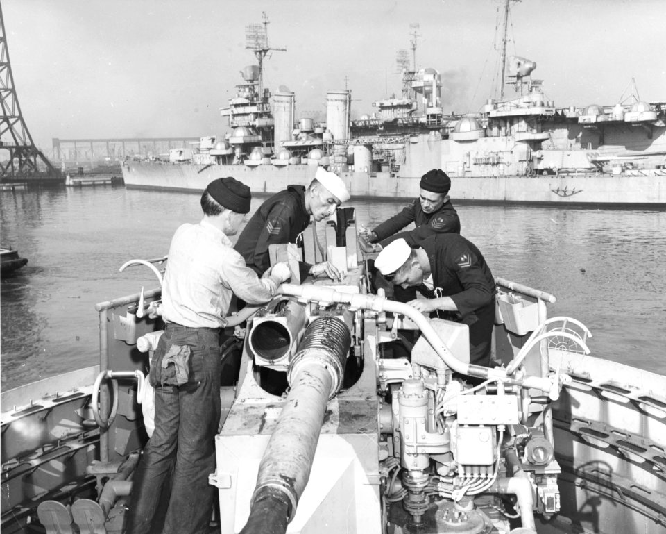 Brazilian sailors working on a 40mm gun mount aboard the light cruiser Barroso at the Philadelphia Navy Yard on 27 March 1951