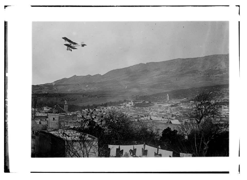 Breguet biplane, type 1910, flying over a town, possibly in Morocco LCCN2014689643