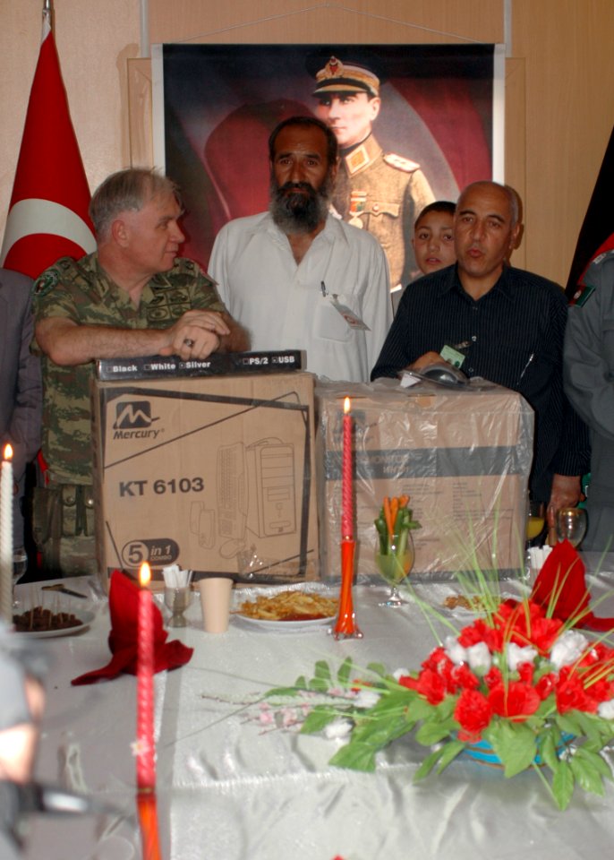 Brigadier General Mustafa Colak gives a computer to an Afghan counterpart (4699311881)
