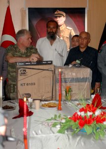 Brigadier General Mustafa Colak gives a computer to an Afghan counterpart (4699311881) photo