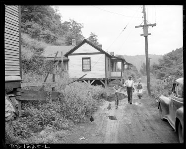 Bringing home groceries. All streets are unpaved, no sidewalks, no camp maintenance. Kingston Pocahontas Coal... - NARA - 540742