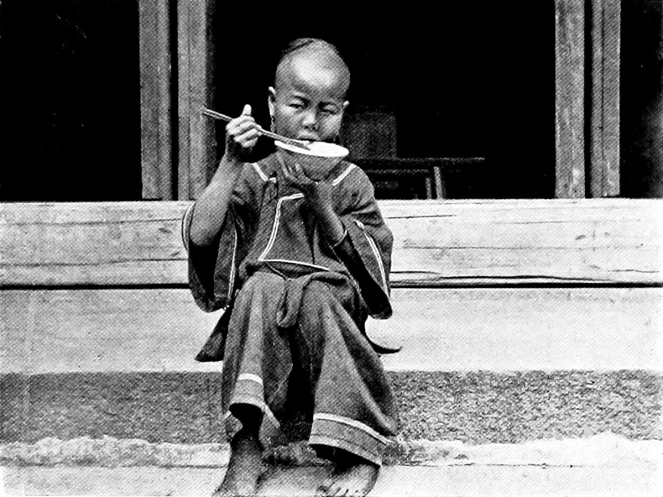 Child Eating Rice with Chopsticks