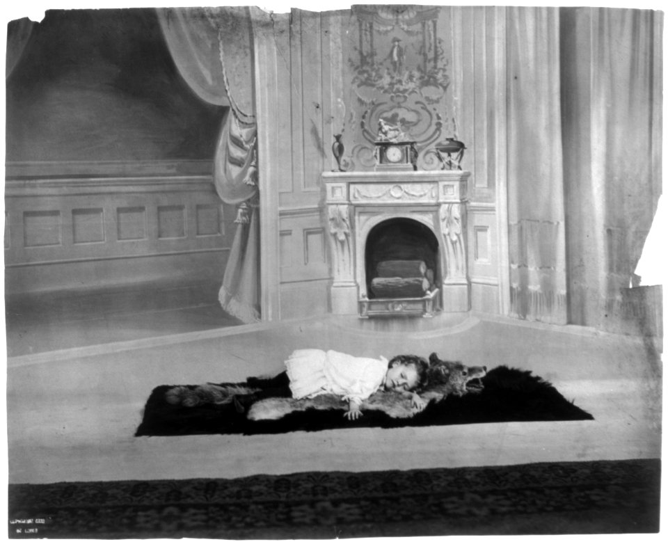 Child sleeping on wolfskin rug LCCN2002699170