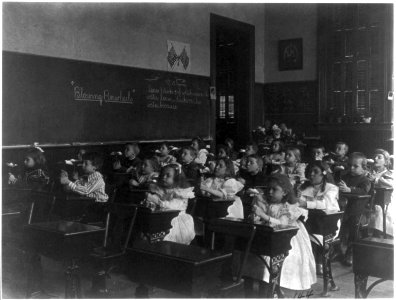 Children in a classroom blowing pinwheels in a Washington, D.C., grade school LCCN2001703714