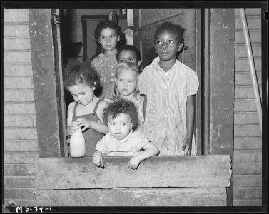 Children of miners standing at door of company house. Christopher Coal Company, Christopher ^3 Mine, (Formerly... - NARA - 540235