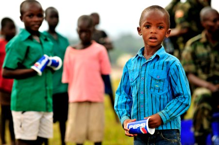 Children of Uganda Peoples Defense Force soldiers stand watching a graduation ceremony at the UPDF Non-Commissioned Officers Academy in Jinja. DVIDS214544