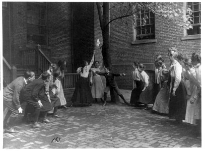 Children playing game with handkerchief on stick in school yard, Washington, D.C. LCCN2001703698